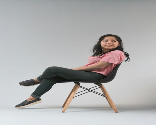 Person doing gentle neck stretches while sitting on a chair